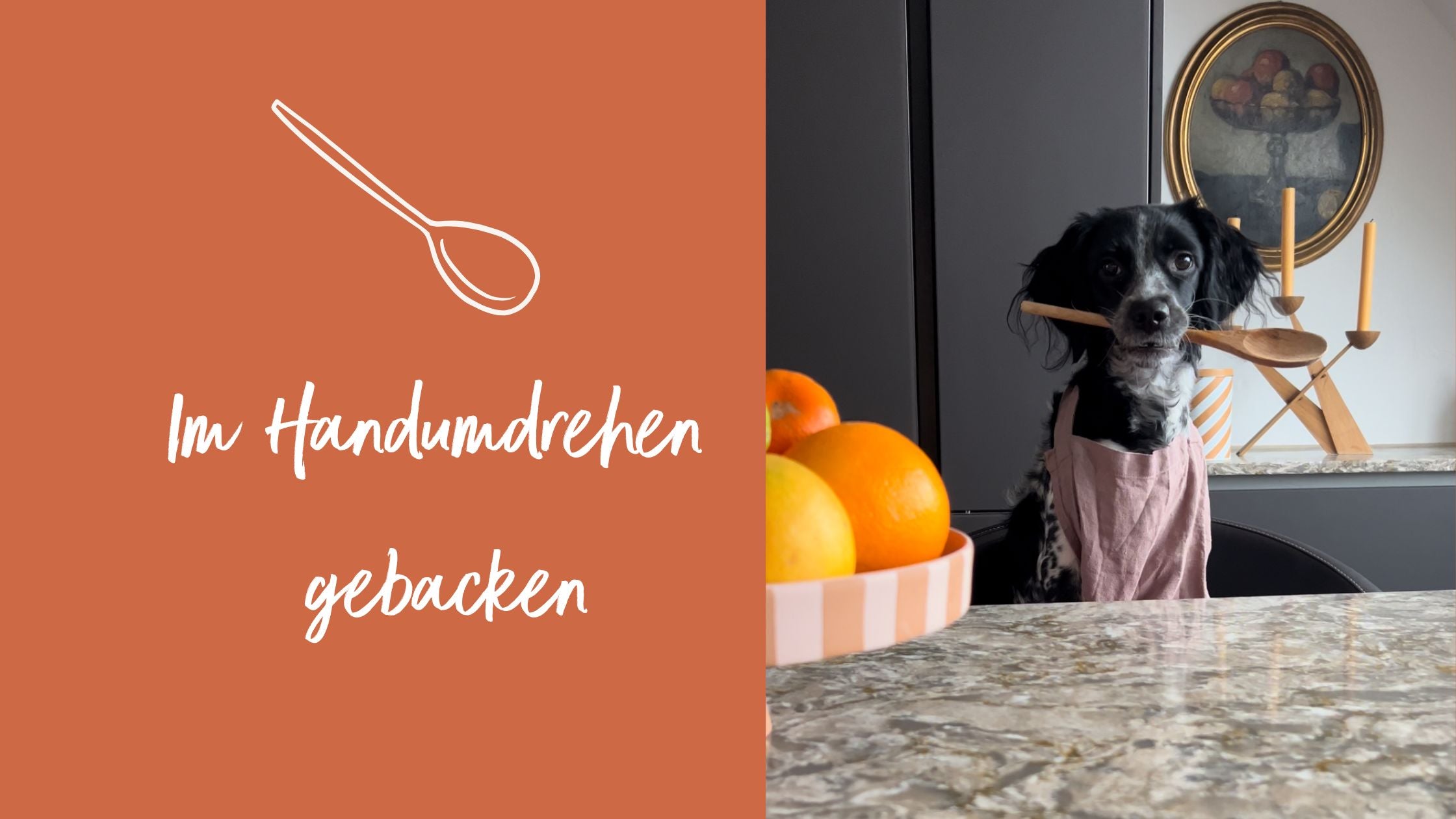 Süßer Hund mit Kochlöffel aus Holz im Mund und einer Schürze umgebunden.